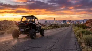 Nevada UTV street legal - Polaris RZR with Montana plates driving on paved Nevada highway with Las Vegas skyline at sunset