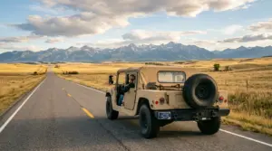 Tan HMMWV M998 driving on Montana highway with Montana license plate, Big Sky landscape, permanent registration through Montana LLC